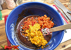 adding chopped spicy peppers into mix